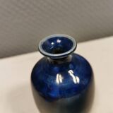 A small vase with blue running glaze with a ‘thin’ neck, from Swedish Kjell Sunesson