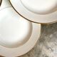9 hollow plates in white and golden Limoges porcelain