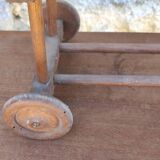 Old rattan cradle on wheels