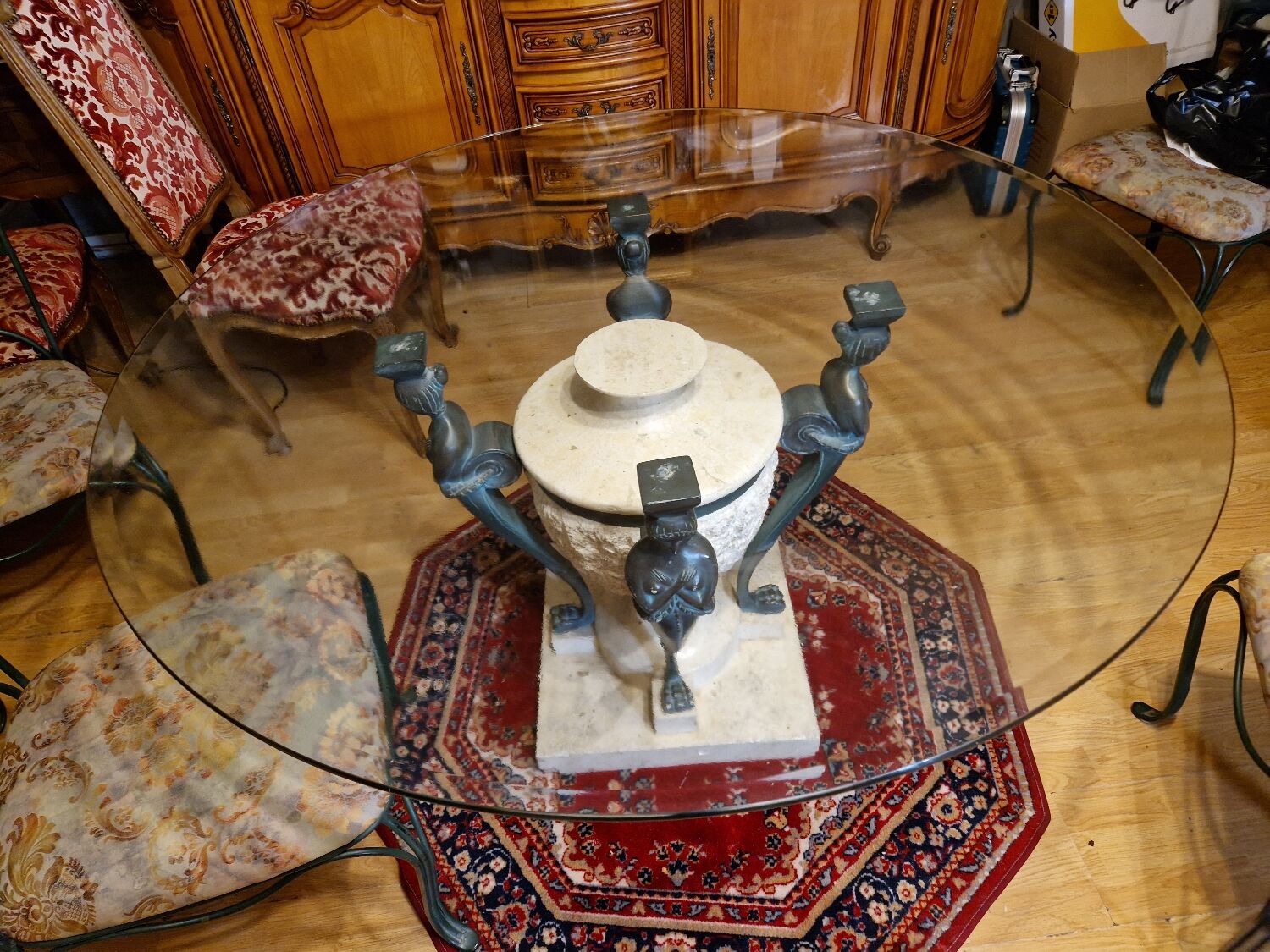 Stone and bronze dining table with ribbed glass top