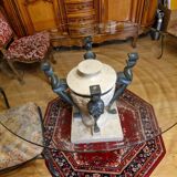 Stone and bronze dining table with ribbed glass top