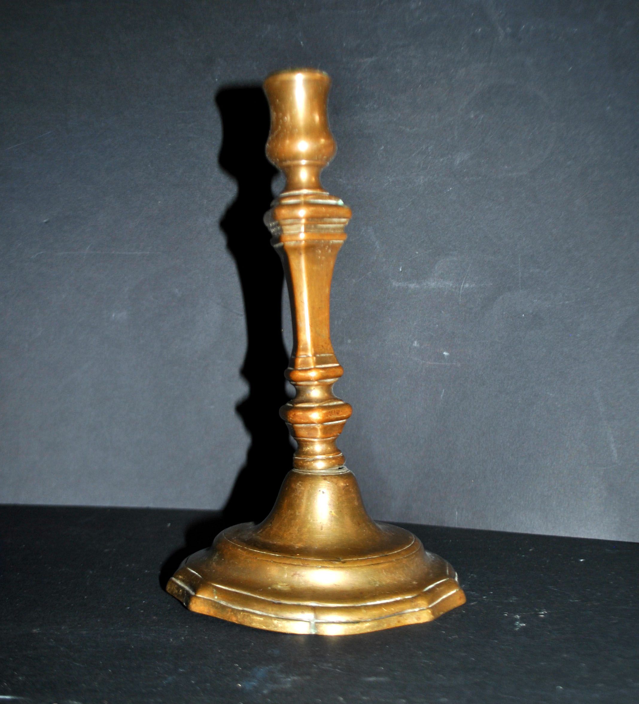 Antique candle holder, carved in bronze, 18th century.