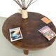 Brutalist coffee table in solid teak, monolithic slab, tripod base.