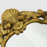 Old wall mirror in wood and gilded stucco with shell decoration, Louis XV style pediment mirror