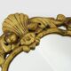 Old wall mirror in wood and gilded stucco with shell decoration, Louis XV style pediment mirror