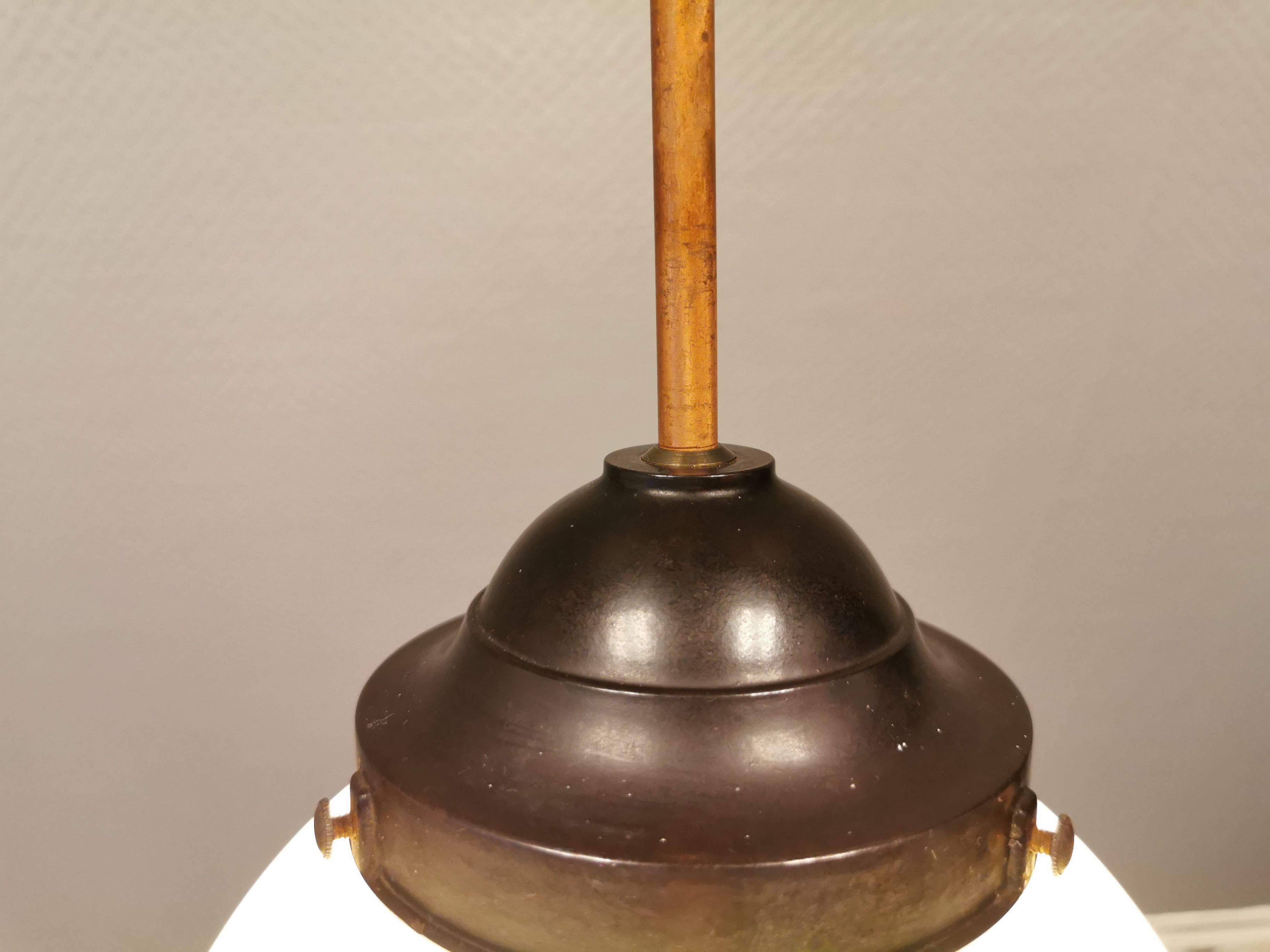 Small Art Deco hanging lamp in cream coloured glass and bakelite top.