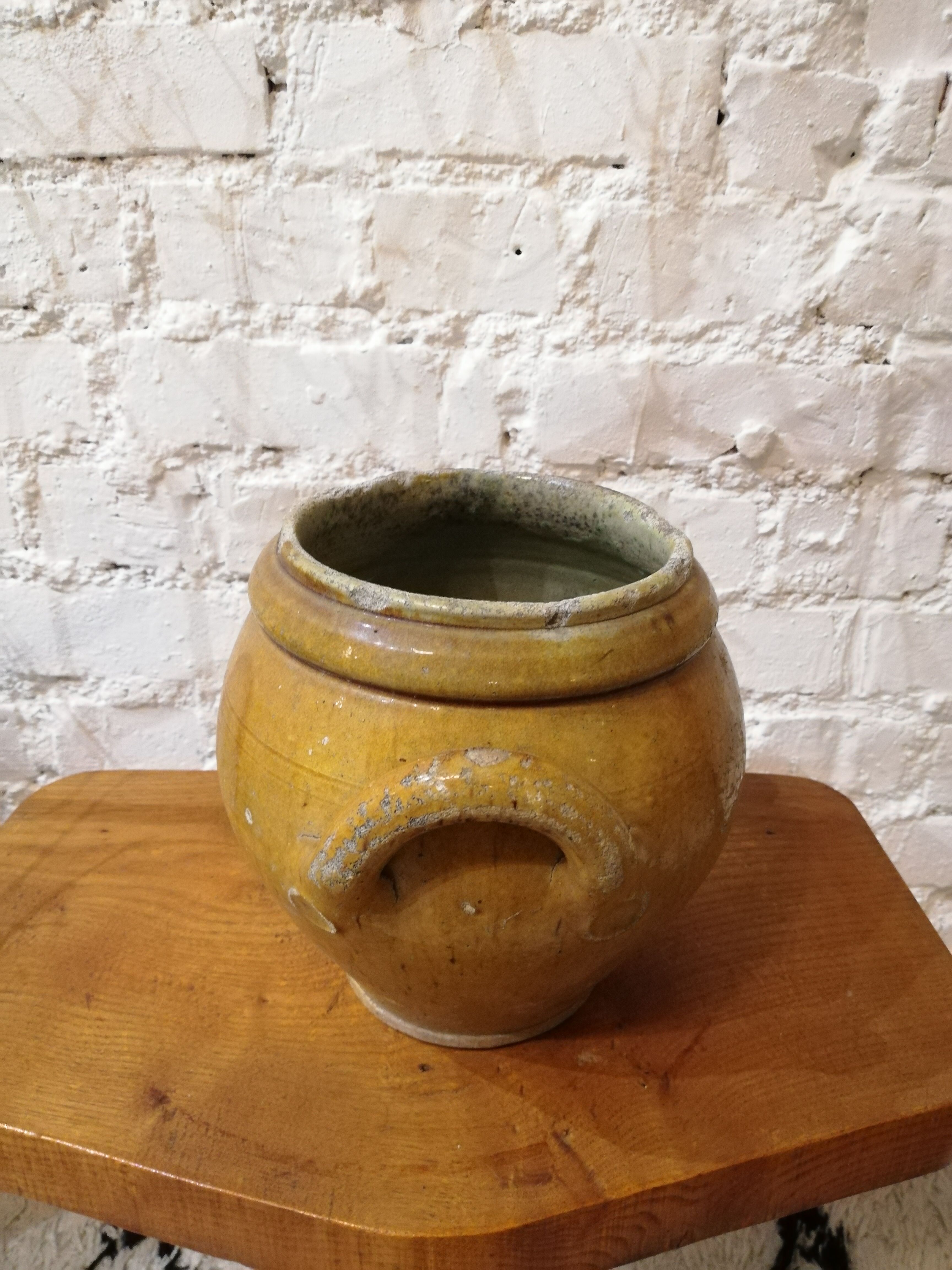Old yellow glazed terracotta pot