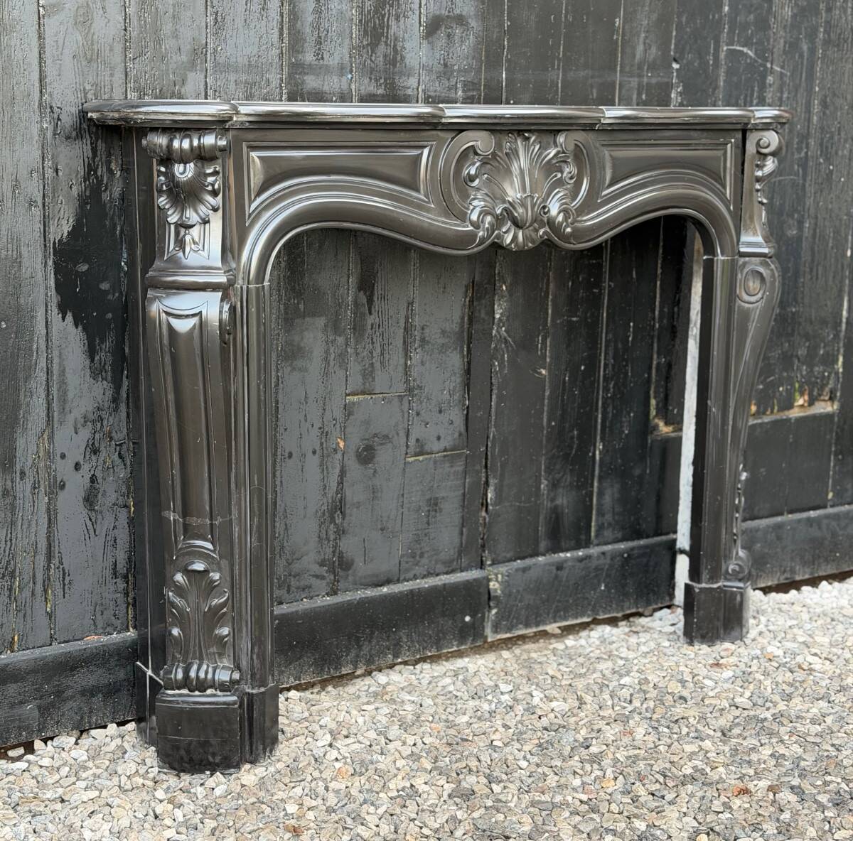 Louis XV style fireplace in black Belgian marble, circa 1880.