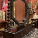 Antique English mahogany dressing table with carved details, black marble, and mirror.
