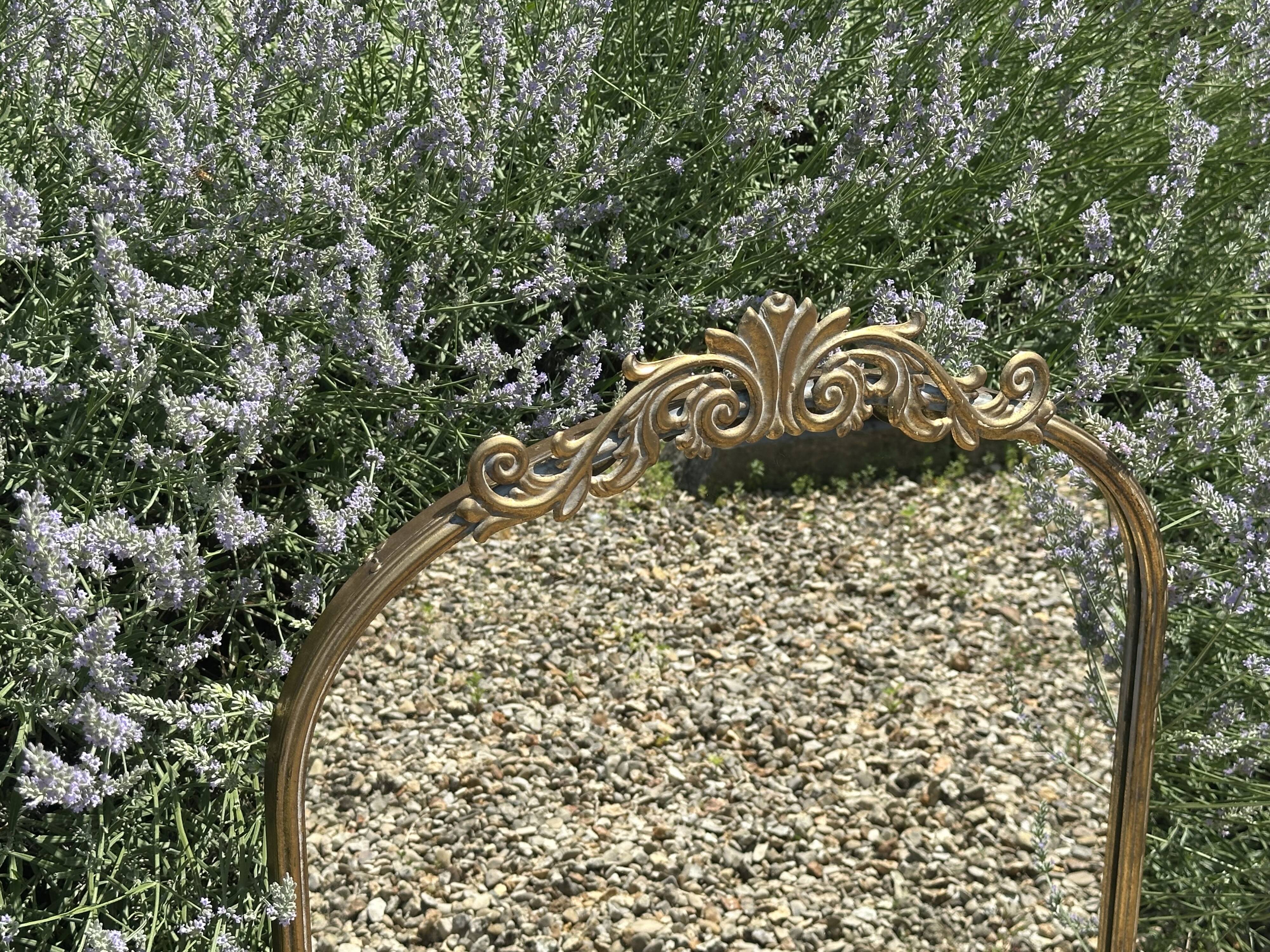 Golden metal pediment mirror from the 2000s.