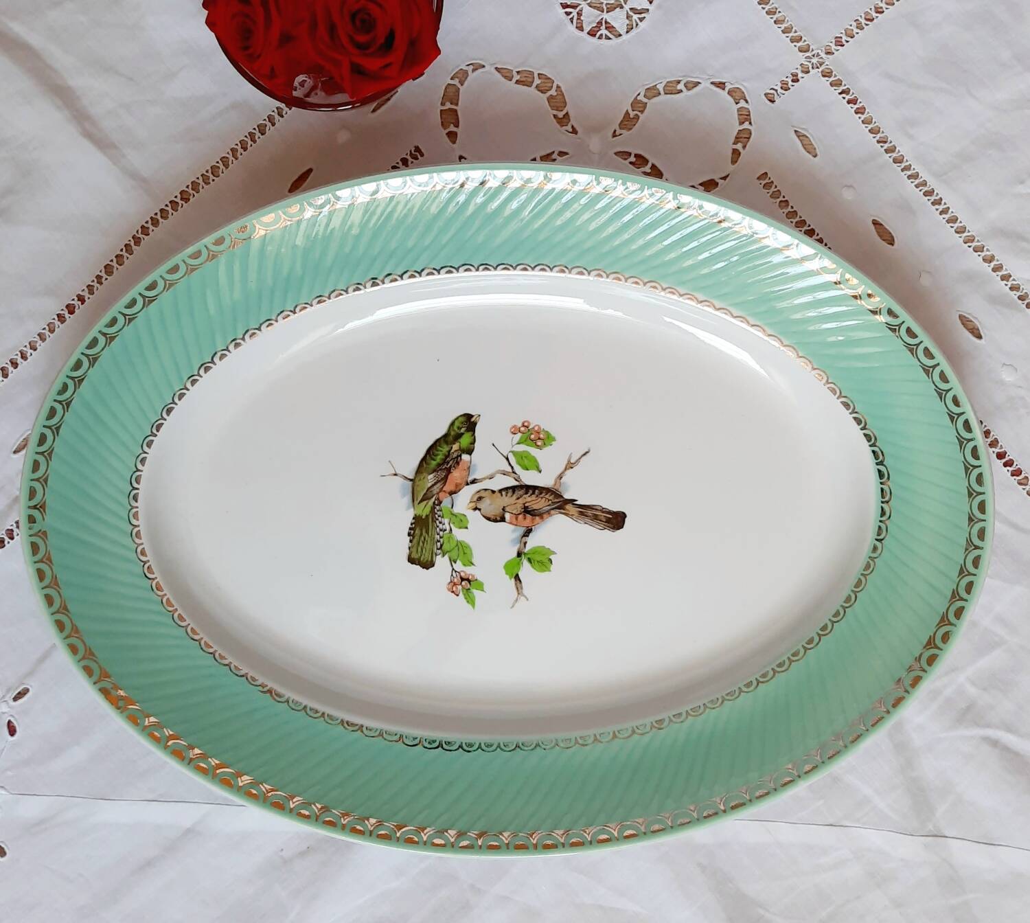 Old mismatched earthenware dinner plates with gold accompanied by a dish