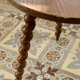 Vintage circular side table in wood with turned legs.