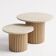 Round nesting coffee table in travertine and raw fluted wood.