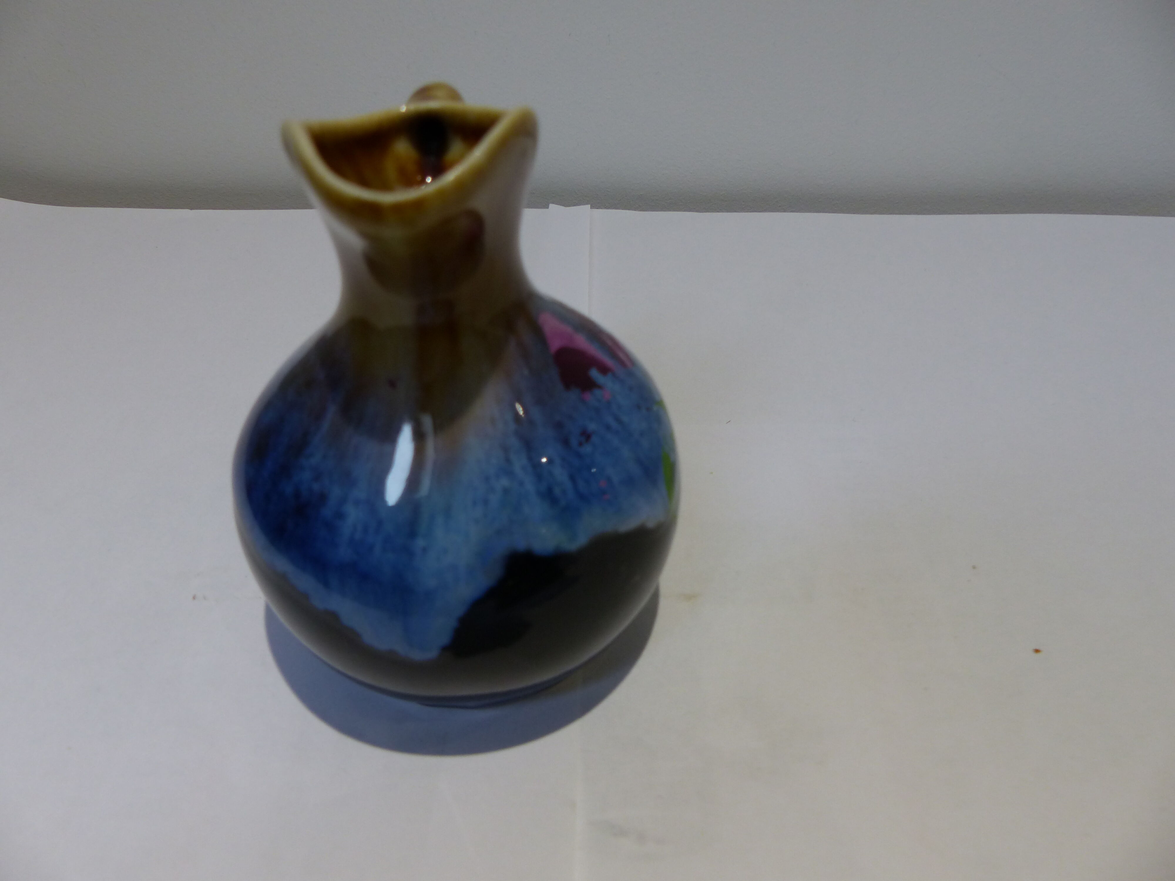 Small vintage ceramic pitcher Blue and brown black reflections