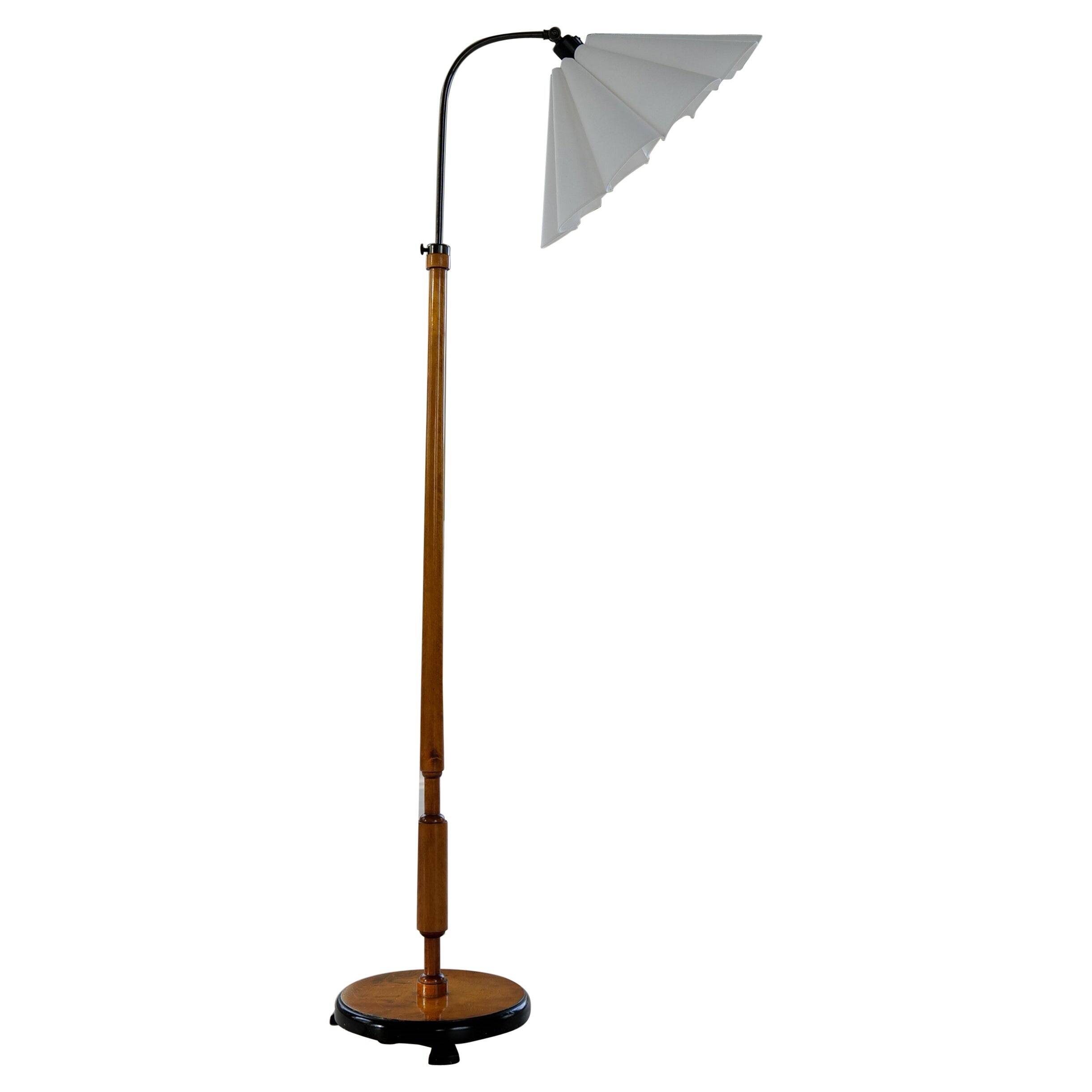 Organic Art Deco floor lamp in stained birch, Sweden, 1930s.