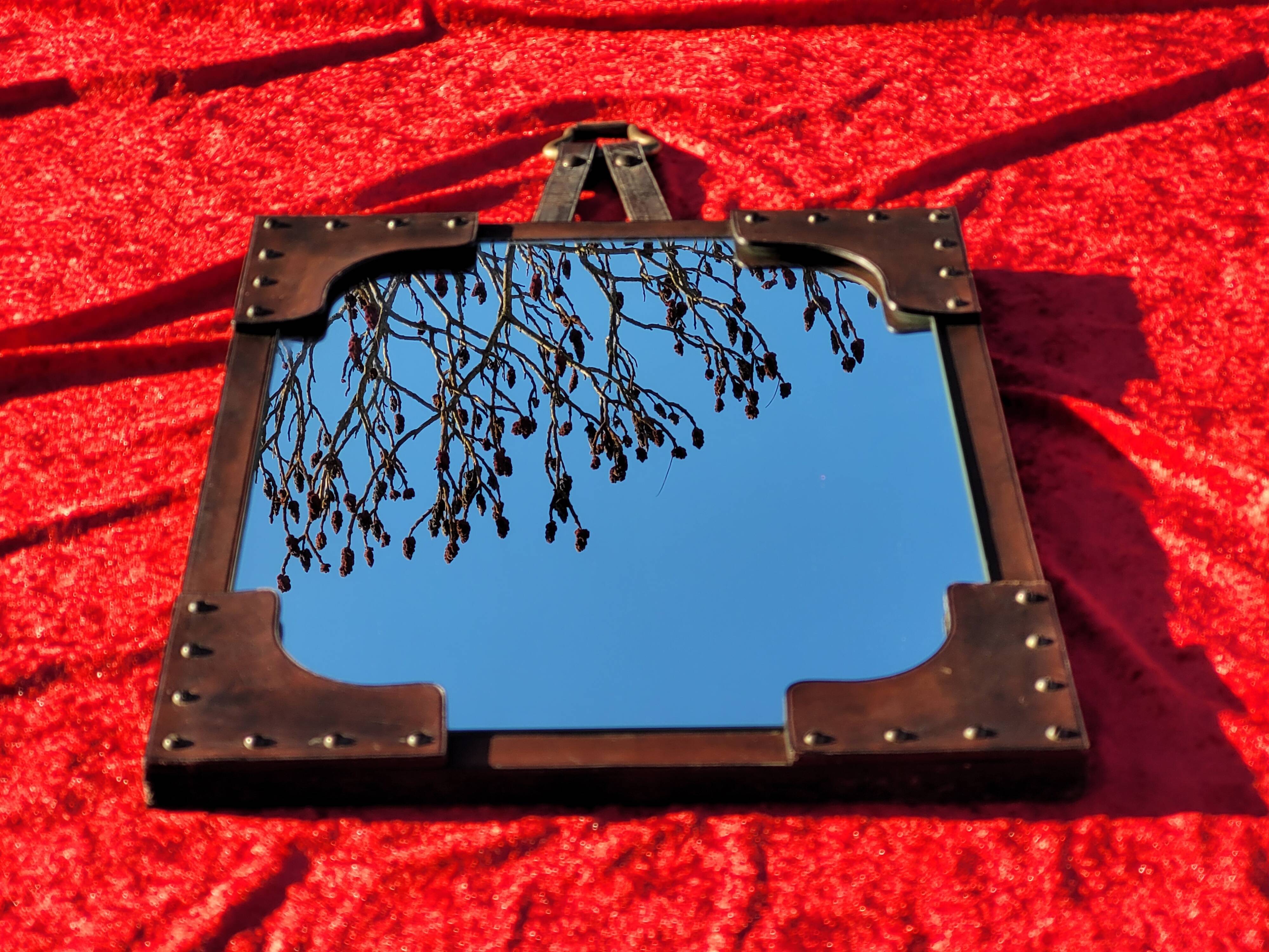 Leather-covered wall mirror attributed to Jacques Adnet 1950