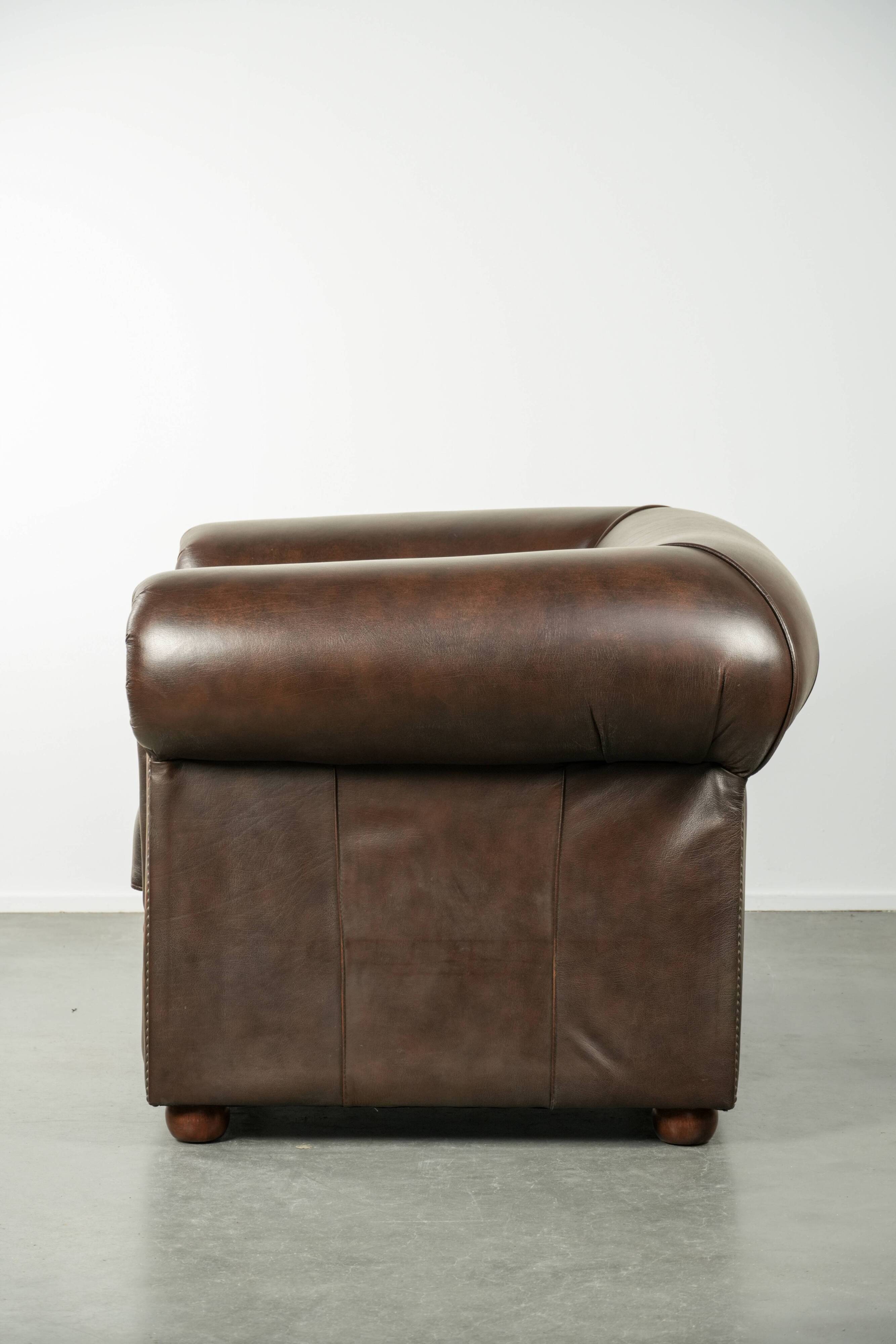 Set of a smooth chesterfield sofa and armchair with a timeless English look