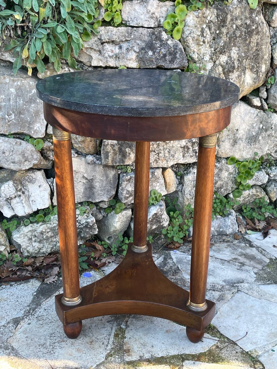 Empire style mahogany and mahogany veneer tripod pedestal table