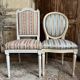 Pair of Louis XVI style chairs in painted wood and satin, classic elegance.