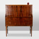 Rosewood chest of drawers with 2 drawers, forming a secretary. 1970s.