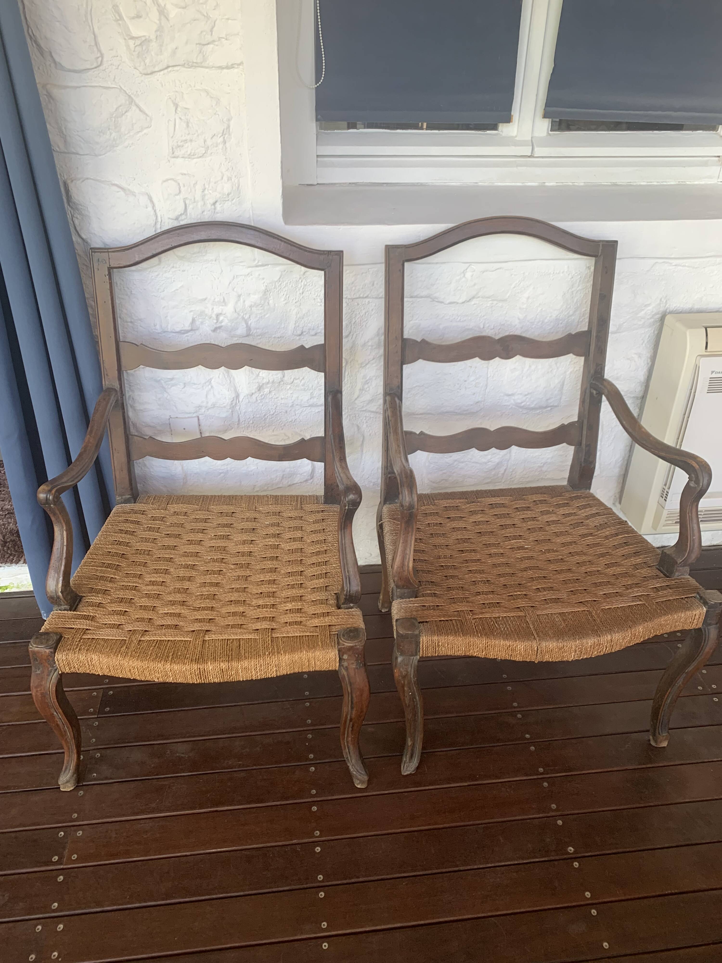 Pair of antique wooden armchairs with woven seats + cushions