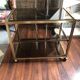 Vintage brass serving trolley with smoked glass trays.