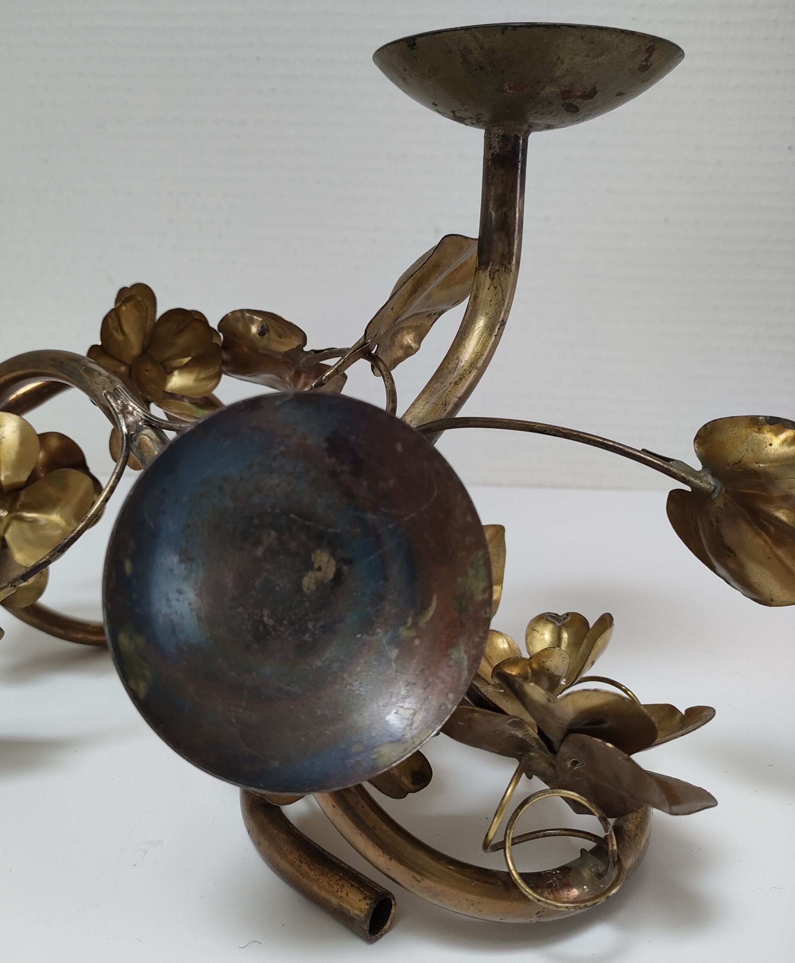Pair of brass candle holders decorated with patinated metal flowers