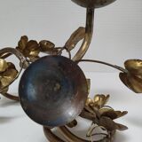 Pair of brass candle holders decorated with patinated metal flowers