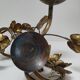 Pair of brass candle holders decorated with patinated metal flowers