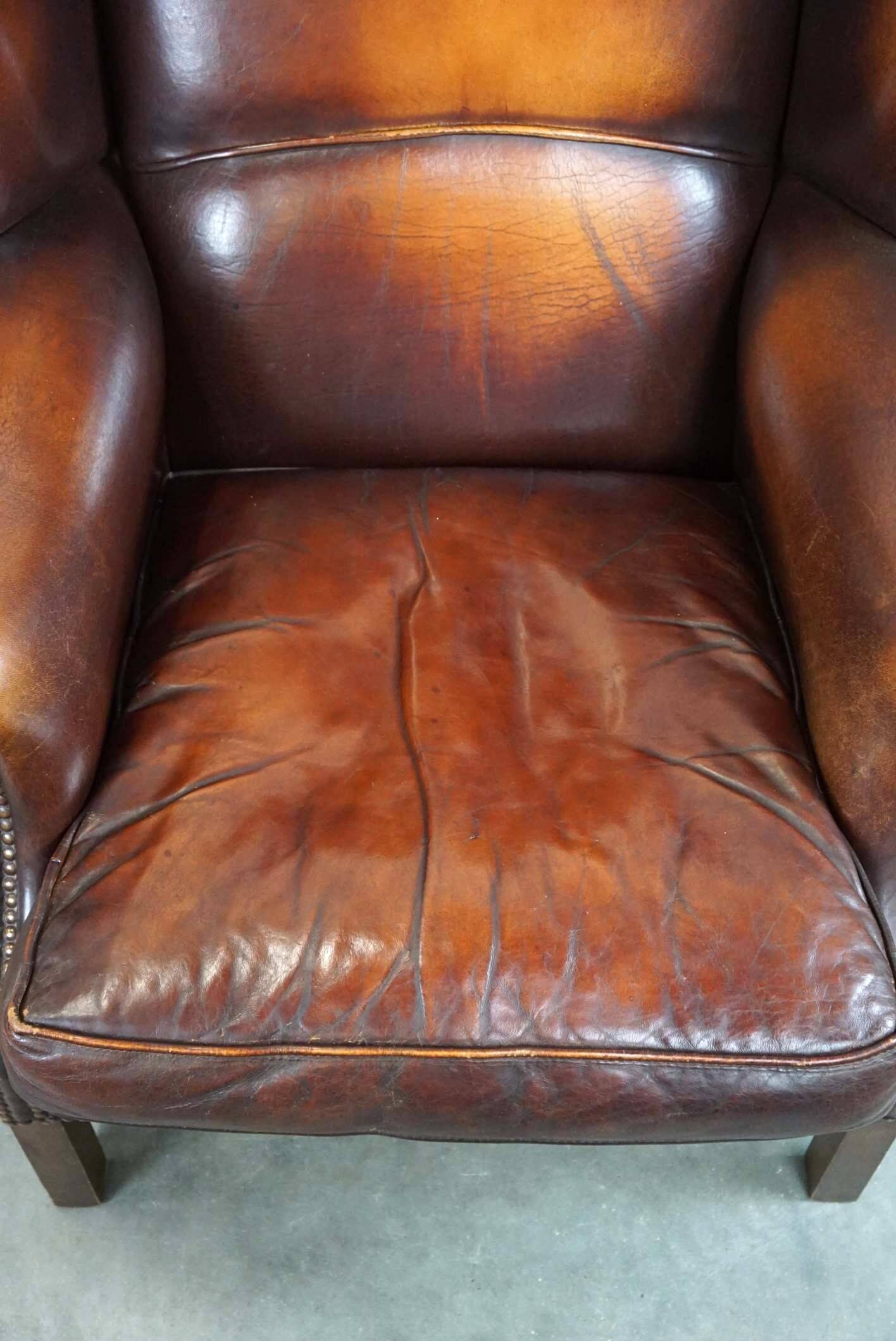 Beautiful classic and stately wingback armchair made of sheep leather with beautiful colors
