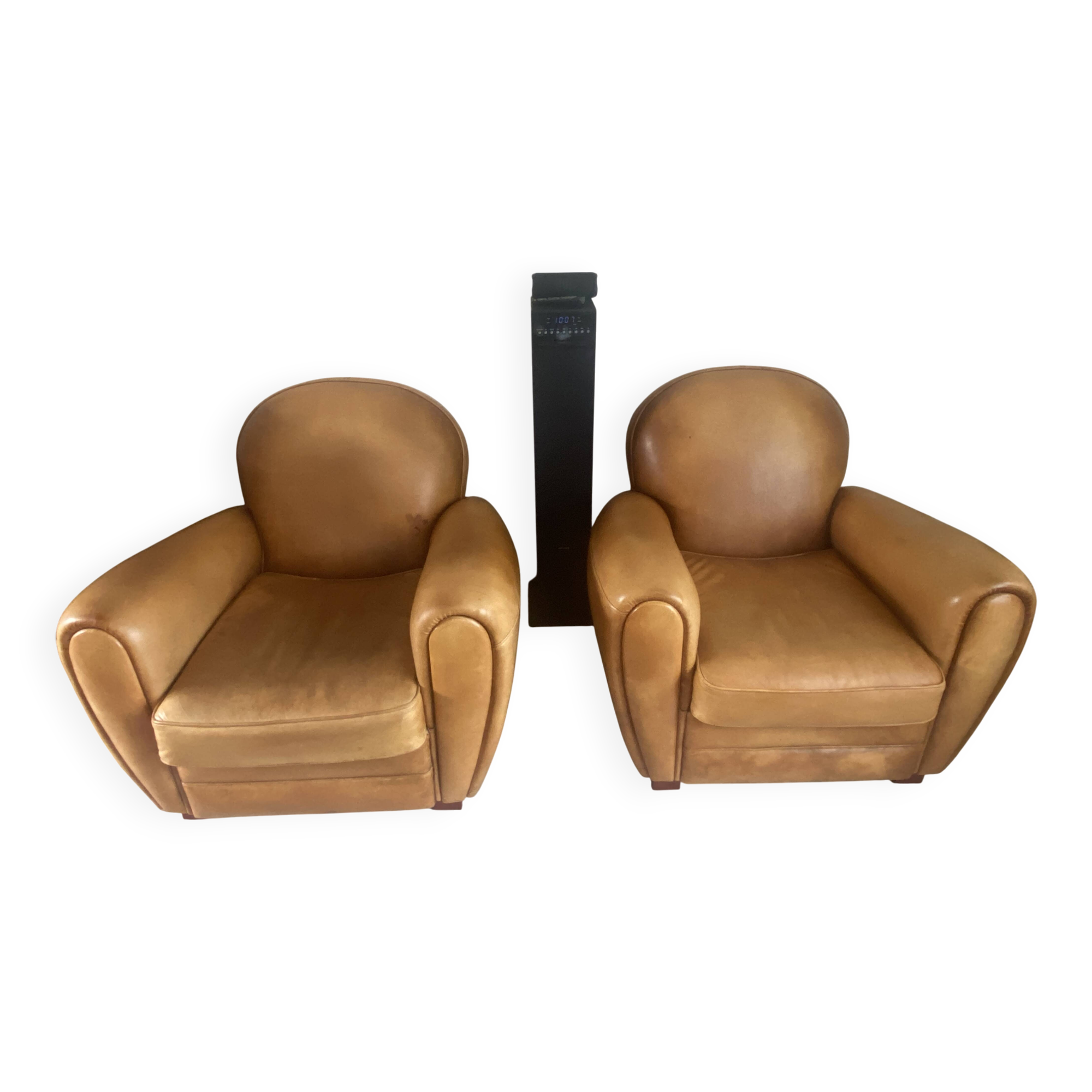 Brown leather club armchairs with an antique finish.