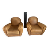 Brown leather club armchairs with an antique finish.