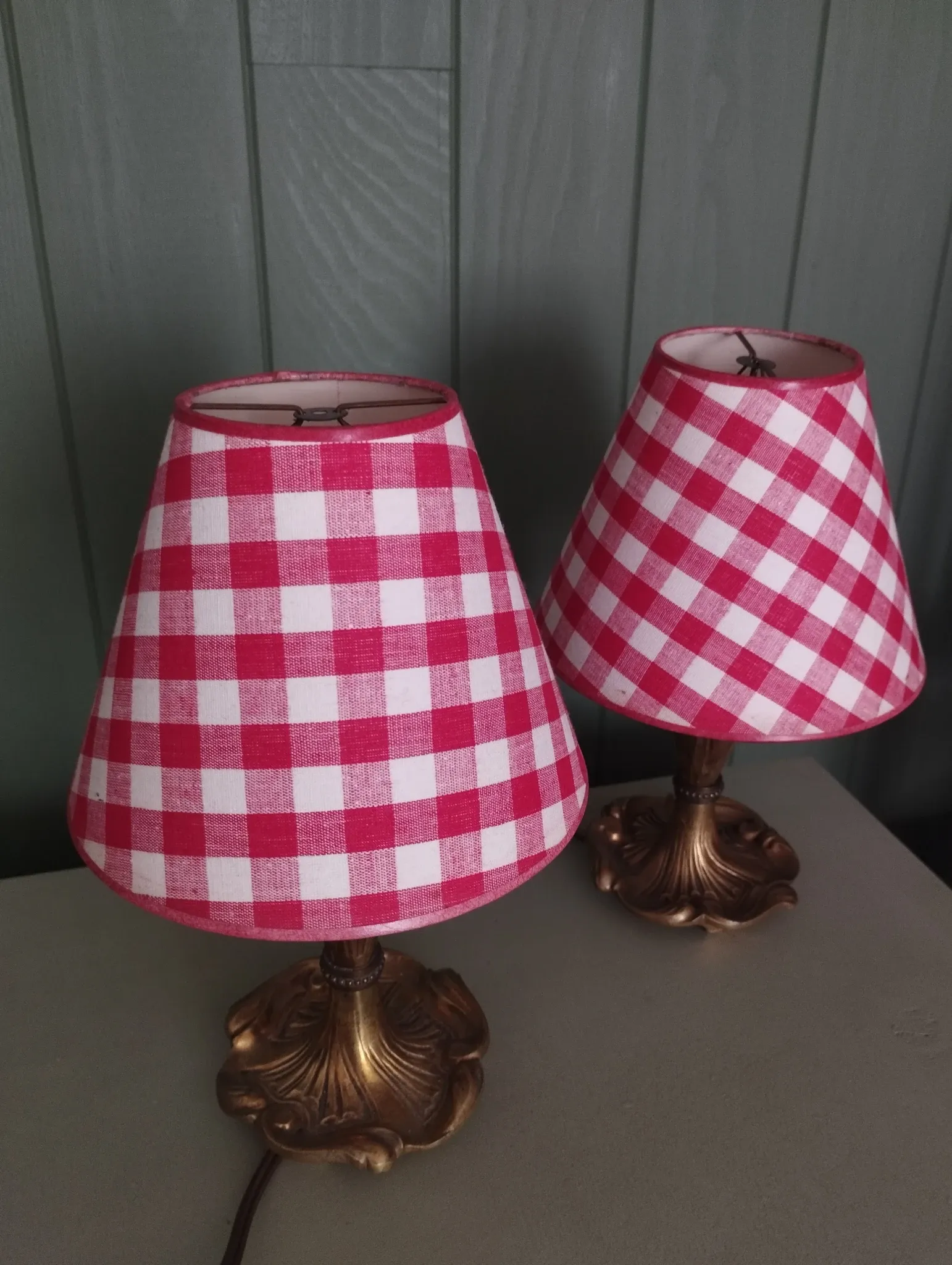 Pair of small lamps in gilded bronze by Petitot and red gingham lampshades.