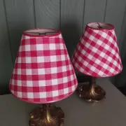 Pair of small lamps in gilded bronze by Petitot and red gingham lampshades.