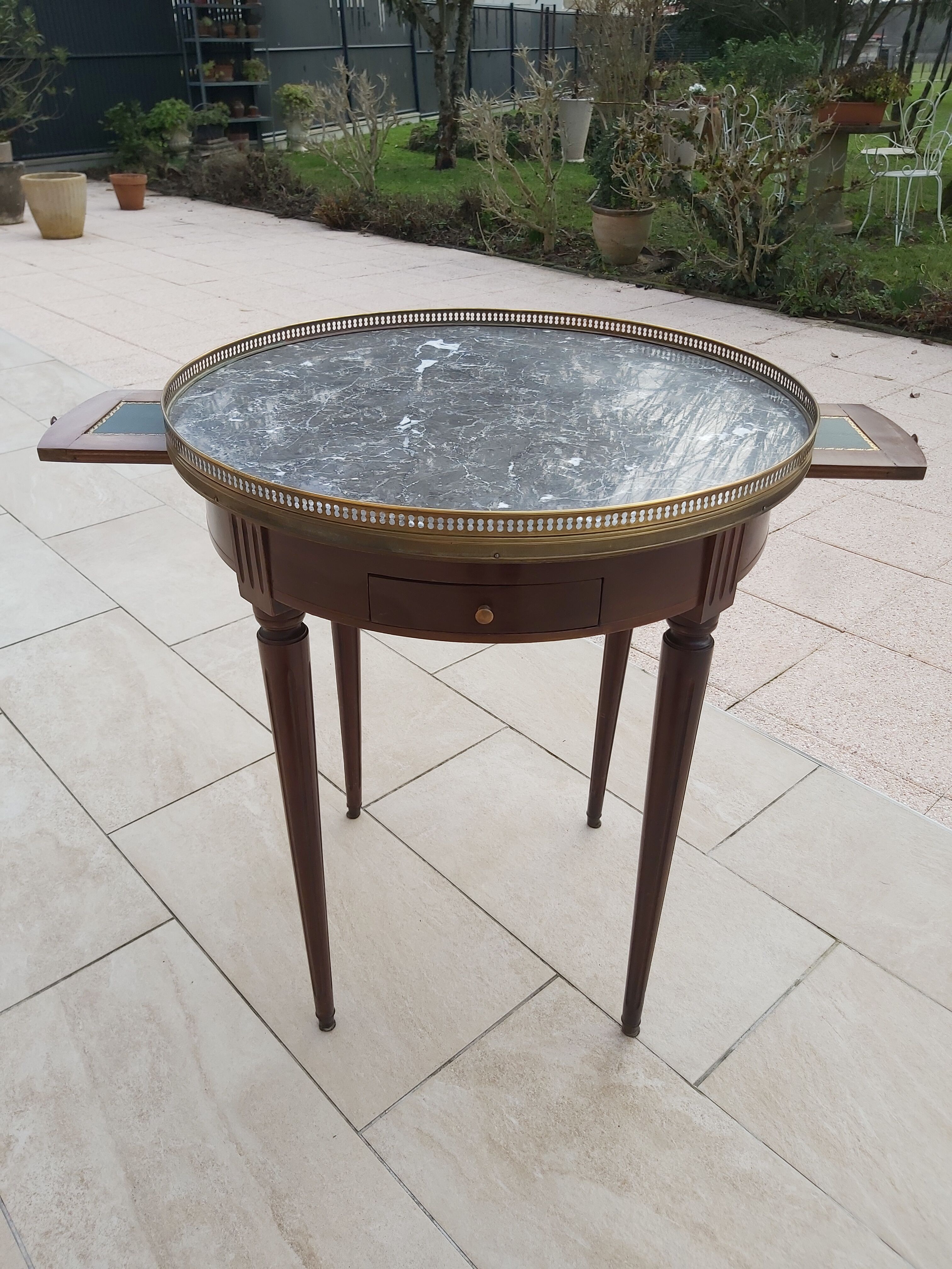 Gray marble mahogany pedestal table and brass gallery