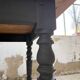 Oak farmhouse table with turned black legs.