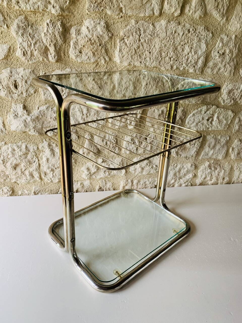 Glass and brass side table with magazine rack, circa 1970's