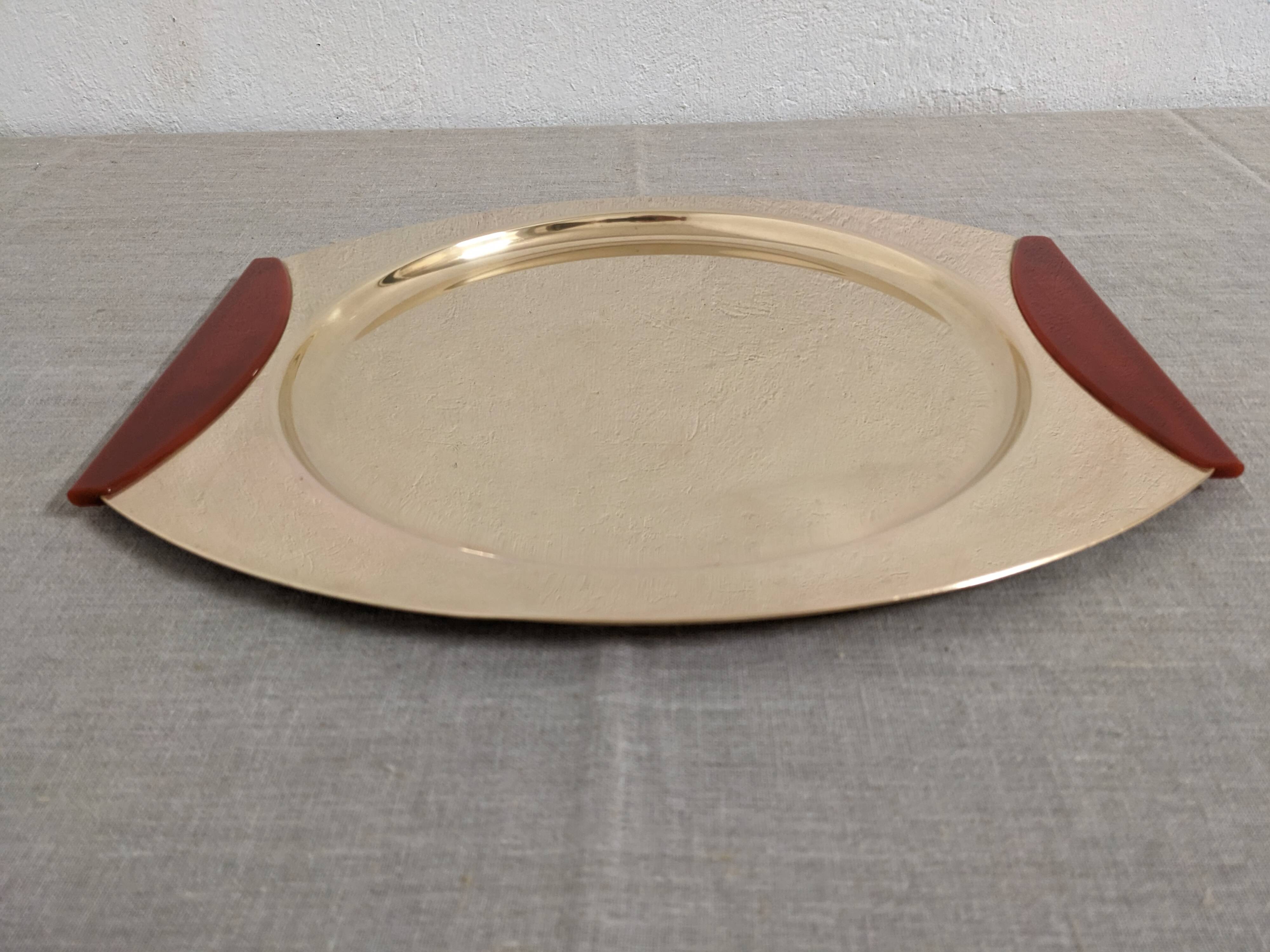 Plates and a brass and Bakelite cut by PM Italy, Italy around 1970.