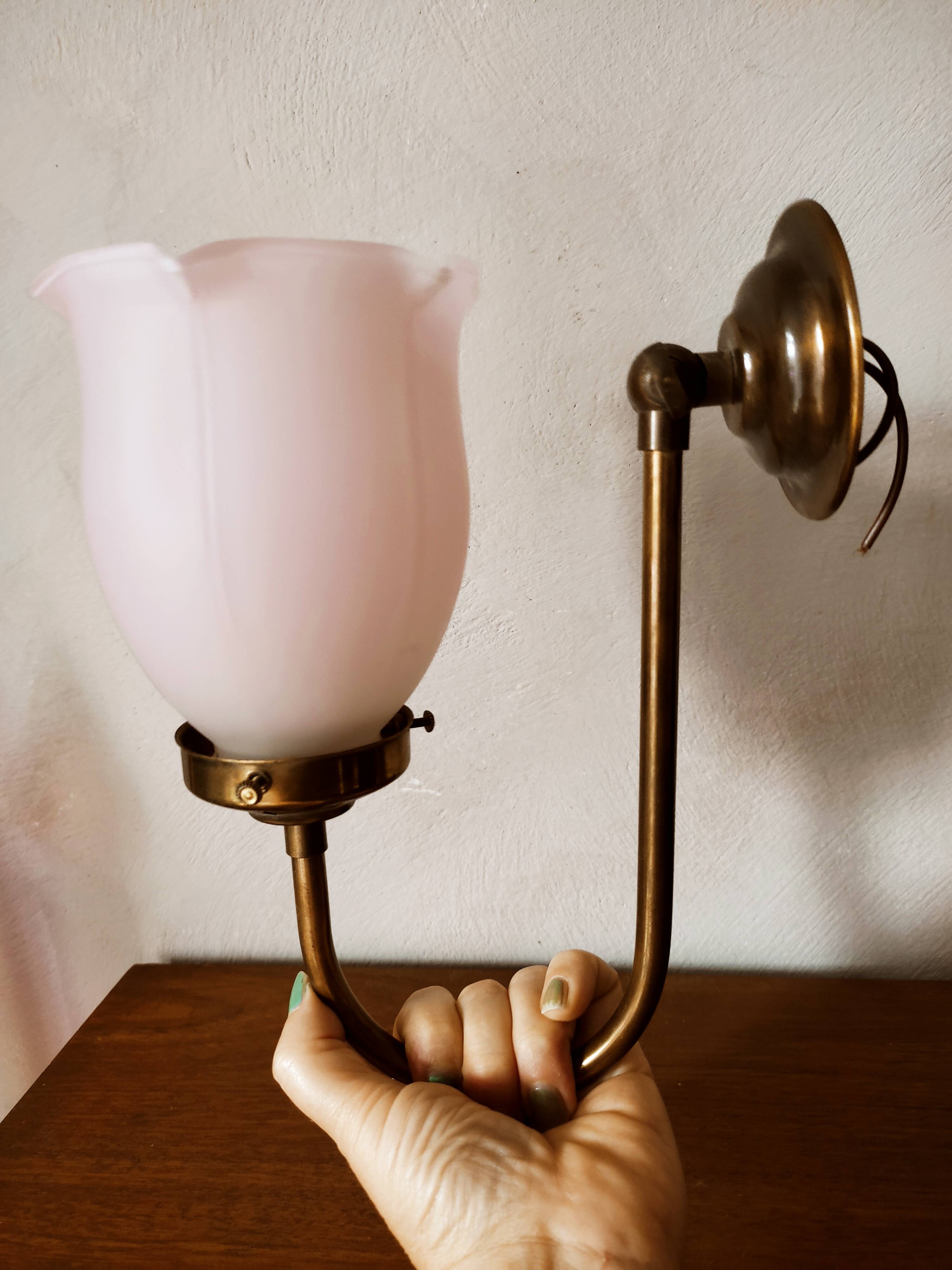 Brass wall lamp with pale pink bell