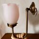 Brass wall lamp with pale pink bell