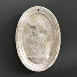 Character on plaster medallion
