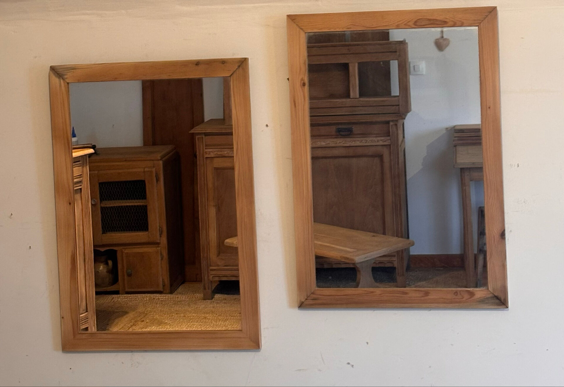 Pair of vintage antique mirrors in raw solid wood.