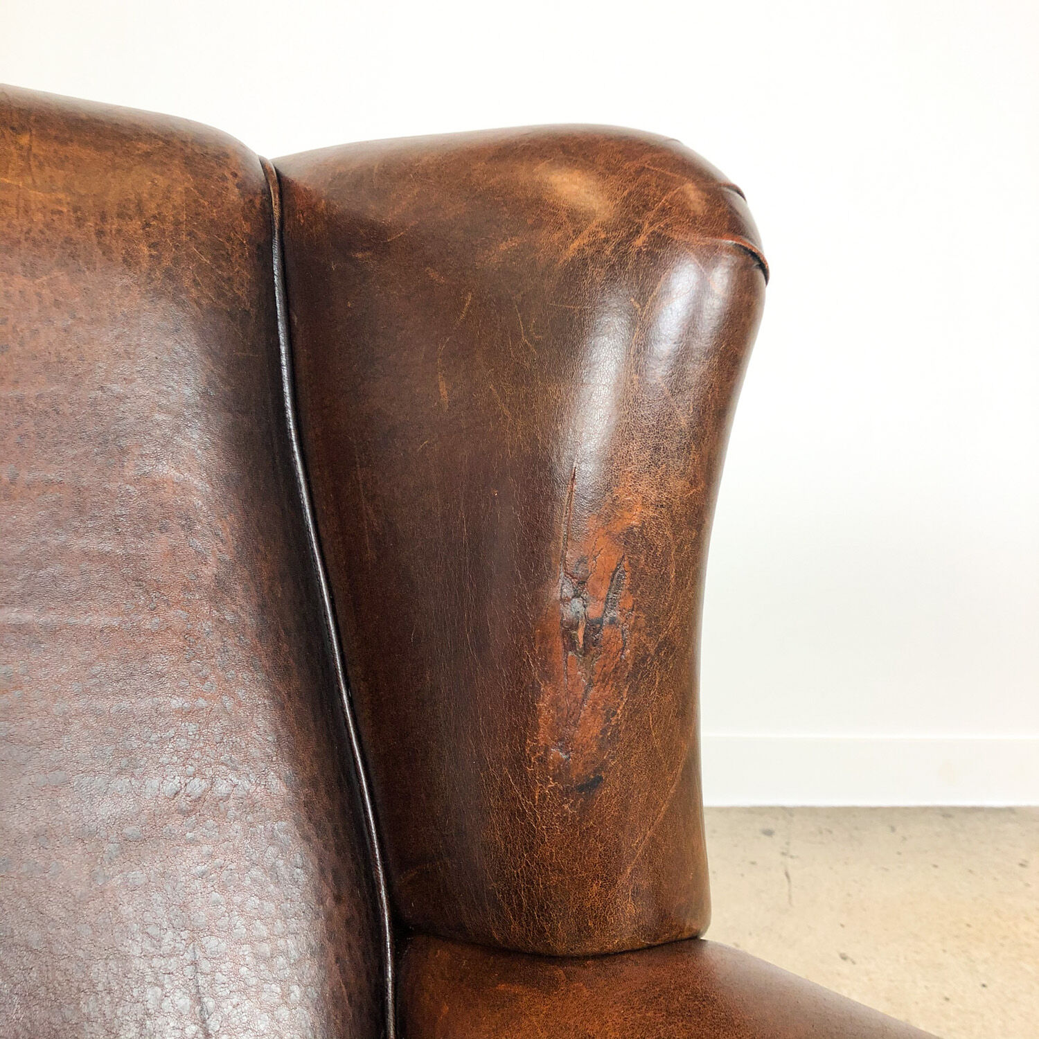 Dark brown sheep leather wingback armchair