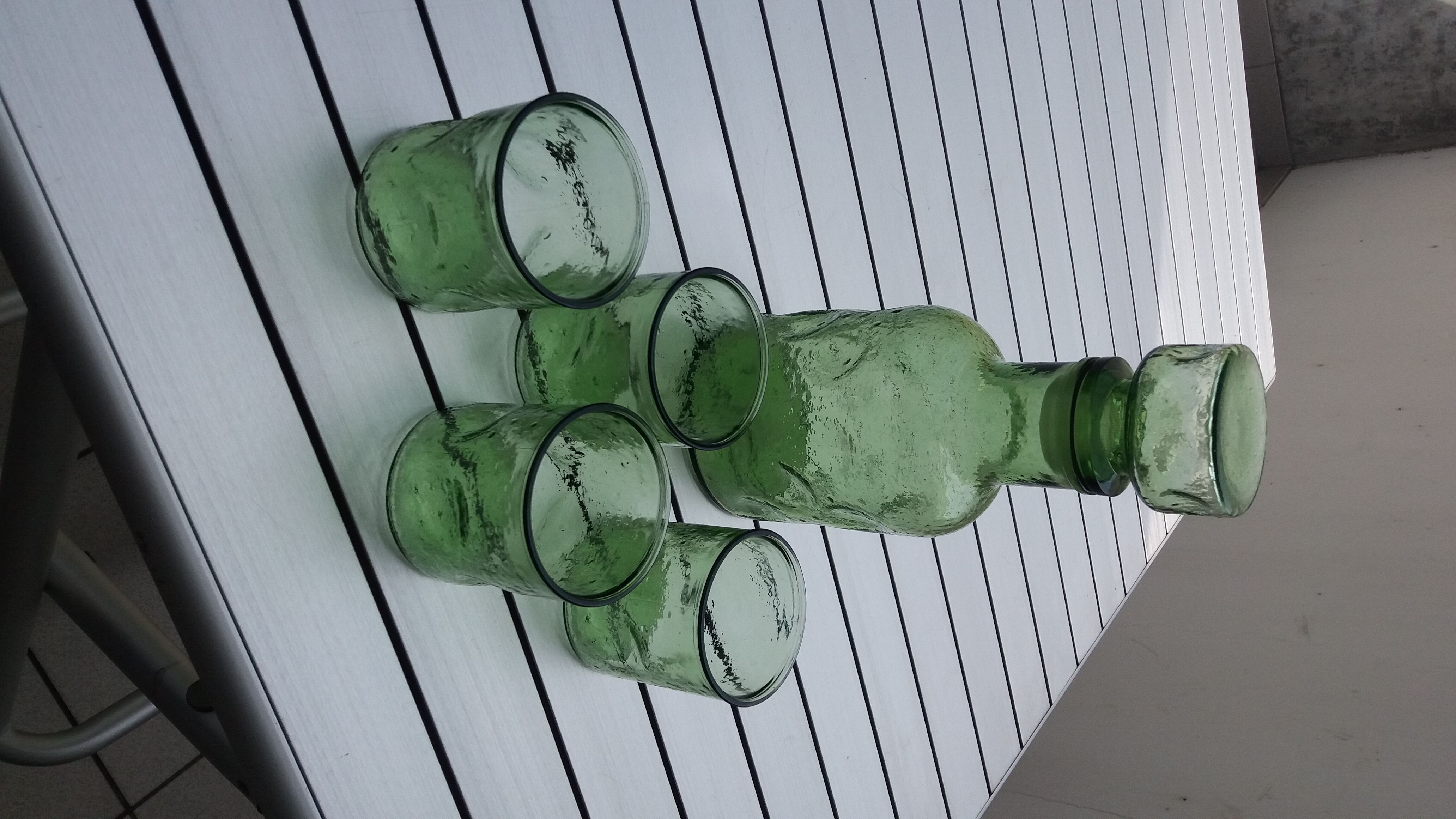 Green carafe in green bulb and assorted vintage glasses