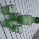 Green carafe in green bulb and assorted vintage glasses