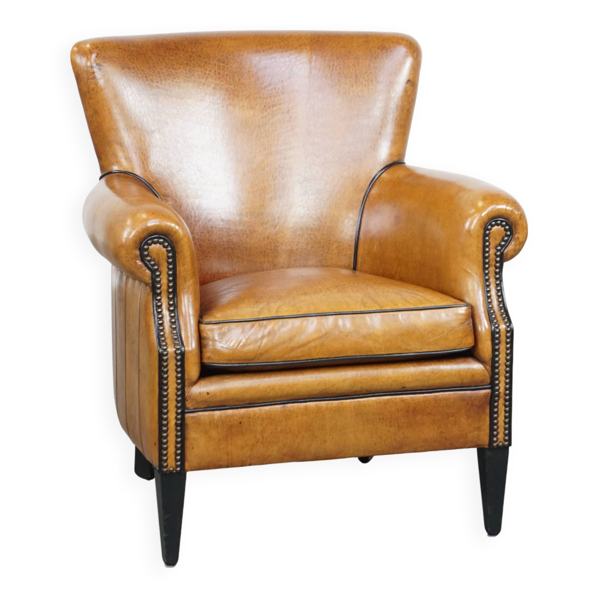 Cognac-colored sheep leather armchair finished with decorative nails