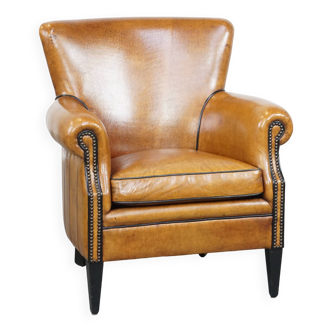 Cognac-colored sheep leather armchair finished with decorative nails