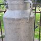 set of 2 old aluminum milk jugs