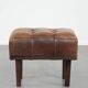 Beautiful sheepskin ottoman on high legs and beautiful warm colours