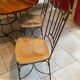 Table and four wrought iron and wood chairs.